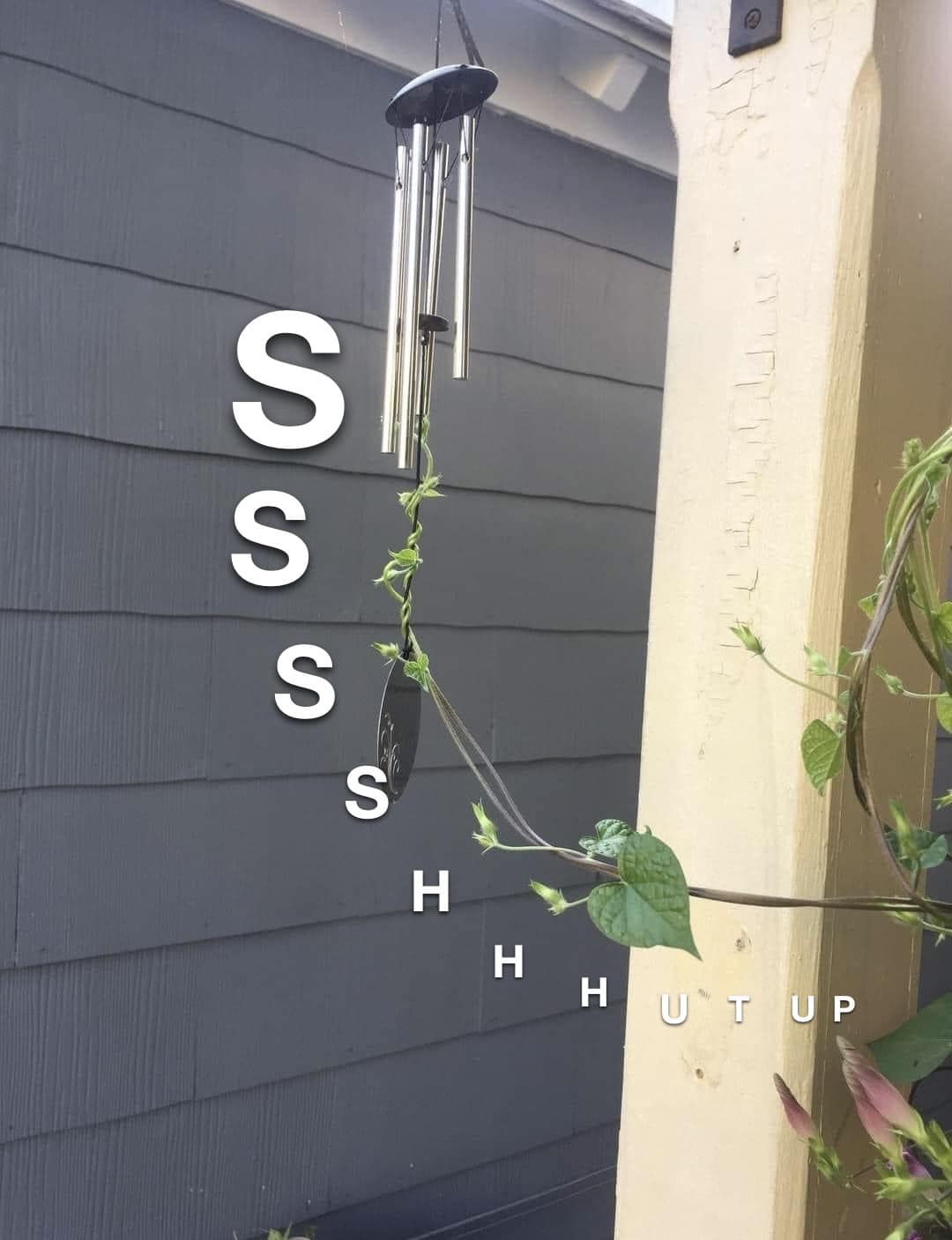 This meme is a simple, humorous image. It shows a wind chime hanging from a porch or balcony, with a plant or vine growing up the support. The text "S" appears vertically on the left side of the image, followed by a series of "S"s, then "S" again, and finally "S", "H", "H", "U", "T", and "U", "P".